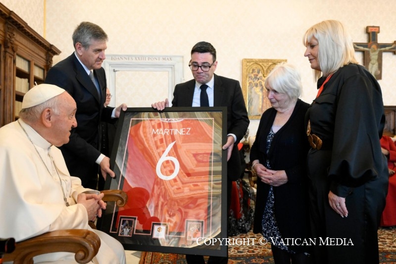 Photo of civic leaders presenting the football-loving Pope with a signed Manchester United shirt. 