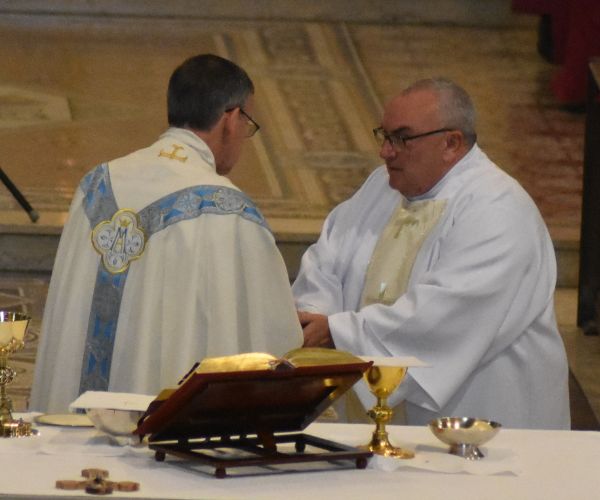 Deacon John assists Bishop John at the altar at Salford Cathedral