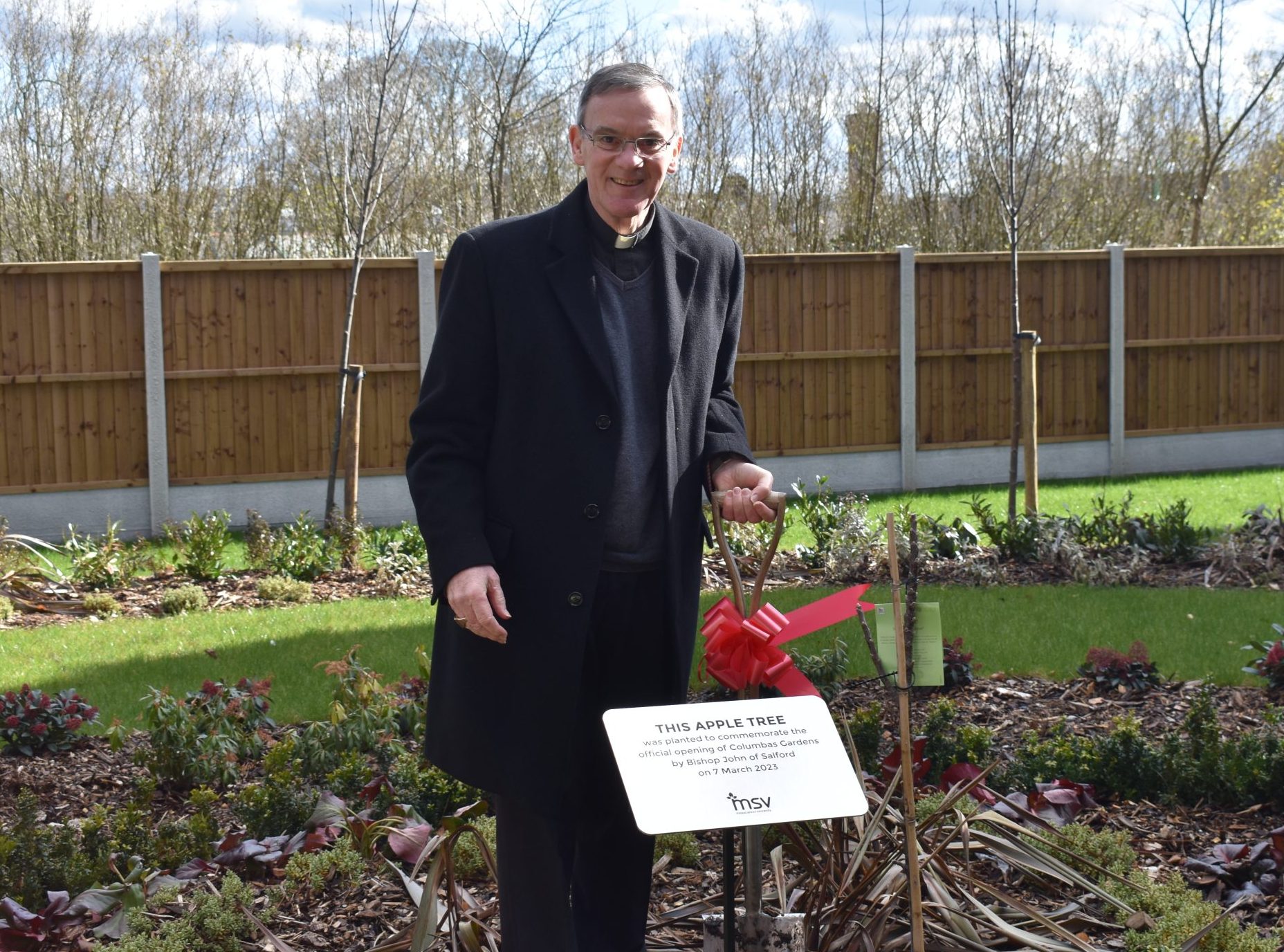 Bishop John launches Columbas Gardens by planting an apple tree