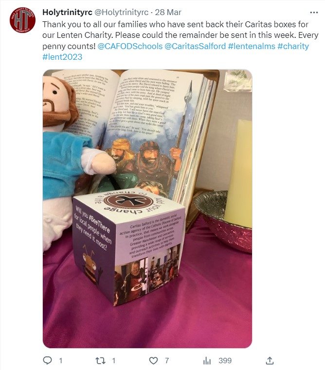 Photo of Caritas' St Joseph's Penny box in front of an illustrated Bible
